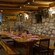 A table set for 10 in a rustic dining area with stone walls